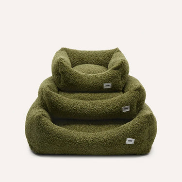 Green pet bed with a soft texture on a white background